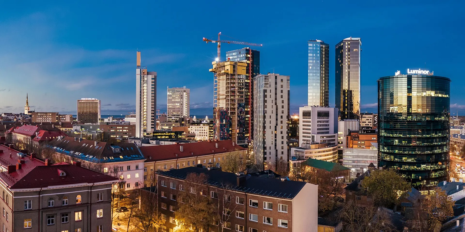 Line producer Estonia base: modern Tallinn skyline at dusk over the city's business district